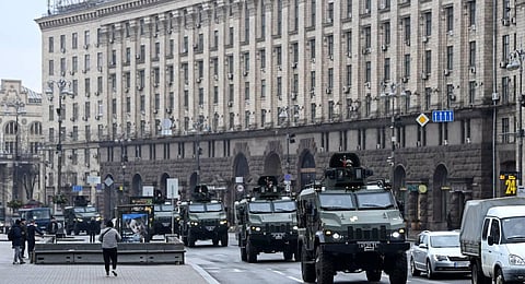 Ukrainian military vehicles move past Independence square in central Kyiv.(Photo | AFP)
