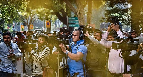 Media personnel outside the BBC office amid a survey operation conducted by Income Tax Department as part of a tax evasion investigation, at KG Marg in New Delhi, Tuesday, Feb. 14, 2023. (PTI)