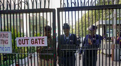 Security personnel close the gate of BBC office on the second day of Income Tax Department's survey operation, conducted as part of a tax evasion investigation, at KG Marg in New Delhi on Feb 15. (PTI
