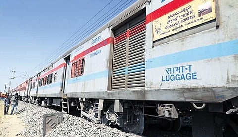 Workers carry out restoration works on the damaged track near Ghatkesar in Hyderabad on Wednesday