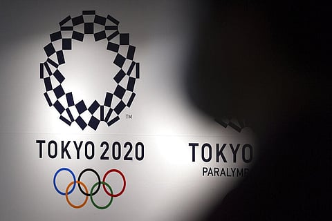 A person walks near Tokyo 2020 logo in Haneda Airport on June 14, 2021, in Tokyo. (Photo | AP)