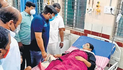 Additional collector Praful Desai, above, consoles a woman who inhaled the leaking chlorine, while a youth recovers at the district hospital in Jangaon on Thursday