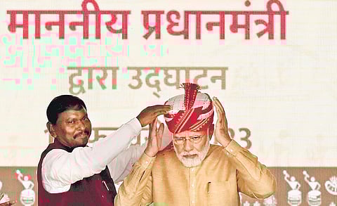PM Modi being presented a Tripuri turban by Minister for Tribal Affairs Arjun Munda at the inauguration of ‘Aadi Mahotsav’ in New Delhi on Thursday | Shekhar yadav
