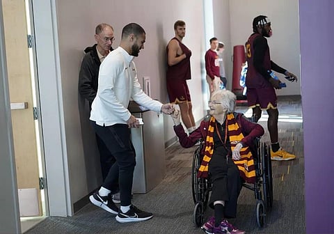 London Dokubo, Director of Operations for the Loyola men's basketball team fist bumps Sister Jean Dolores Schmidt before a team practice on Monday, Jan. 23, 2023, in Chicago. (Photo | AP)