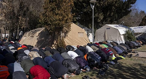 Earthquake displaced people attend Friday prayers at a camp in Kahramanmaras, Turkey. (Photo | AP)