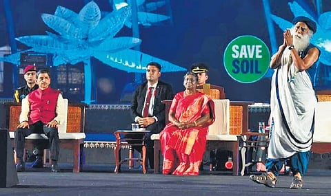 President Draupadi Murmu looks on as Sadhguru addresses devotees gathered at his Isha Yoga Centre near Coimbatore to take part in Mahashivaratri celebrations on Saturday night | special arrangement