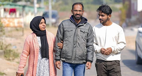 Journalist Siddique Kappan with his wife Raihana and son Muzammil following his release from the Lucknow District Jail, in Lucknow. (Photo | PTI)