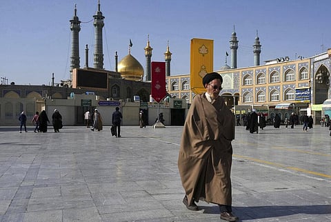 A cleric walks in front of the Fatima Masumeh Shrine in the city of Qom, Tuesday, Feb. 7, 2023. (Photo | AP)