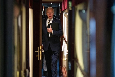 US President Joe Biden walks down a corridor to his cabin on a train after a surprise visit with Ukrainian President Volodymyr Zelenskyy, Monday, Feb. 20, 2023, in Kyiv. (Photo | AP)