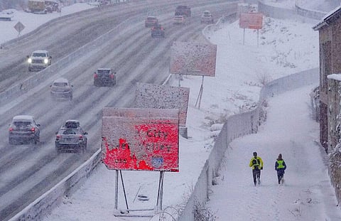Runners negotiate snow covered paths along Interstate 80 in Salt Lake City, Utah., on Wednesday, Feb. 22, 2023. (Photo | AP)
