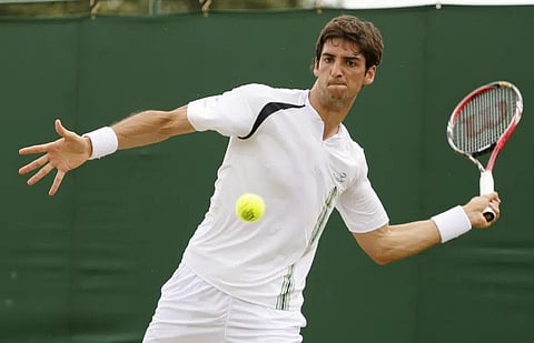 Brazil's Thomas Bellucci makes a forehand return during his match against Austria's martin Fischer at the All England Lawn Tennis Championship at Wimbledon, June 24, 2010. (Photo | AP)