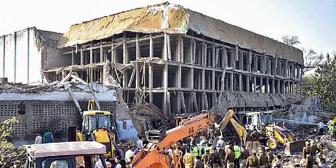 : Rescue operation underway after a wall of a building collapsed at Daurala in Meerut. (Photo | PTI)
