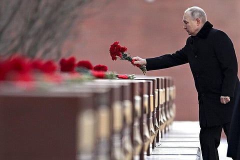 Vladimir Putin attends a wreath-laying ceremony at the Tomb of the Unknown Soldier, near the Kremlin Wall during the national celebrations of the 'Defender of the Fatherland Day' (Photo | AP)