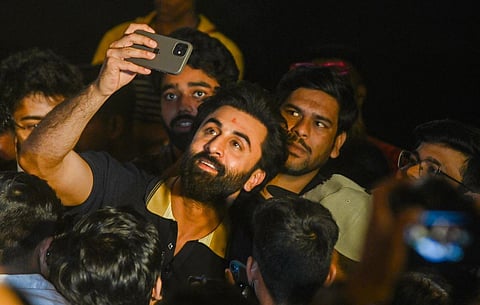 Ranbir Kapoor clicks a selfie with fans during a promotional event for his upcoming film 'Tu Jhoothi Main Makkaar', in Kolkata. (Photo | PTI)