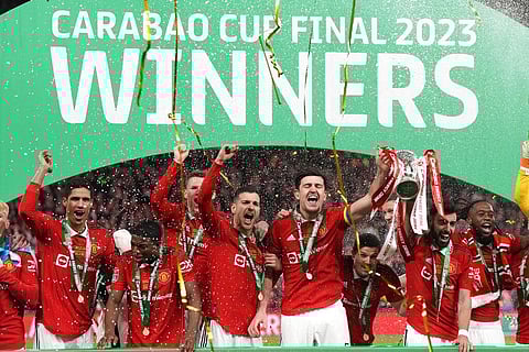 Manchester United's players celebrate with the trophy after winning the English League Cup final at Wembley Stadium in London, Feb. 26, 2023. (Photo | AP)