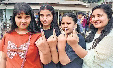 First-time voters show their inked fingers after casting their votes at a polling booth in Meghalaya, at Nongpoh in Ri Bhoi district on Monday | PTI