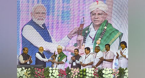 Prime Minister Narendra Modi with Union Minister Pralhad Joshi, Karnataka Chief Minister Basavaraj Bommai and former Karnataka chief minister B.S. Yediyurappa (Photo | PTI)