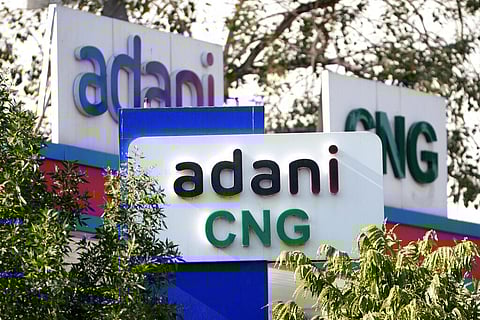 Signage of Adani's compressed natural gas station are displayed at company's outlet in Ahmedabad, India. (Photo | AP)