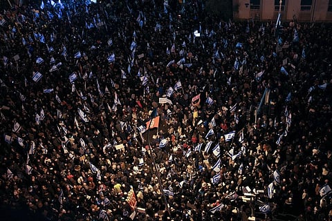 Israelis protest against the plans by Prime Minister Benjamin Netanyahu's new government to overhaul the judicial system, in Tel Aviv, Israel. (Photo | AP)