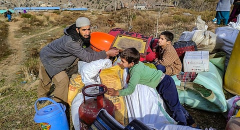 Residents shift their belongings from the land subsidence-affected Nai Basti area, in Doda district, Jammu & Kashmir. (Photo | PTI)