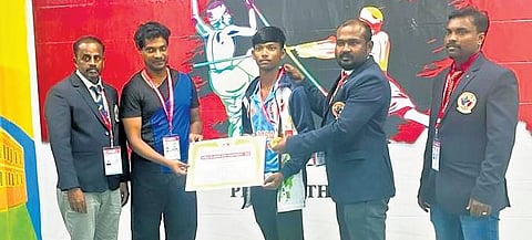 K Sravan Kumar receiving gold medal at the World-Level Silambam Open Championship 2023 held in Singapore last month | Express