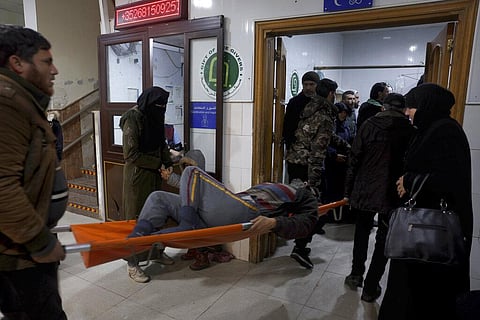 People carry a man injured in an earthquake into the al-Rahma Hospital in the town of Darkush, Idlib province, northern Syria, Monday, Feb. 6, 2023. (Photo | AP)