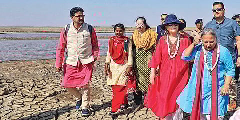 Former USA secretary of state Hillary Clinton with SEWA members and women salt pan workers during her visit to Surendranagar on Monday | PTI
