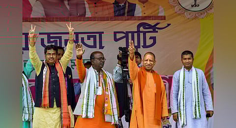 Uttar Pradesh Chief minister Yogi Adityanath with Tripura Chief minister Manik Saha waves during the Vijay Sankalpa Janasabha public rally (Photo | PTI)
