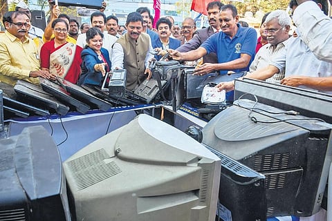 Collector S Dilli Rao dumps condemned electronic devices during e-waste collection drive at IGMC stadium in Vijayawada on Tuesday | Prasant Madugula