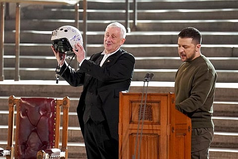 Speaker of the House of Commons, Sir Lindsay Hoyle, left, holds the helmet inscribed with the words 'We have freedom, give us wings to protect it', presented by Ukrainian President Volodymyr Zelenskyy