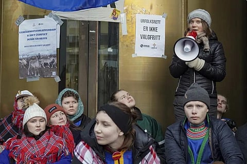Greta Thunberg, right, joins the campaigners including Norwegian Samirs Riksforbund Nuorat who are blocking the entrances to the Ministry of Oil and Energy in Oslo, Feb. 27, 2023. (Photo | AP)