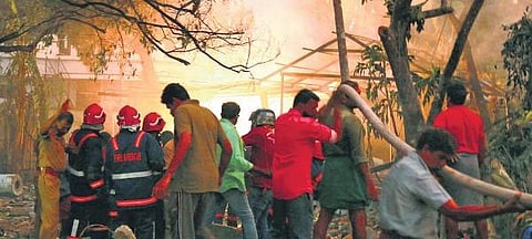 Rescue workers and residents take cover as minor blasts continue at the fireworks manufacturing unit at Muttinakam in Varapuzha, Kochi, on Tuesday | T P Sooraj