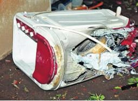 A washing machine that was destroyed at Biju’s house due to impact of explosion