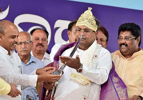 Chief Minister Siddaramaiah was presented a sword by MLA Malikaiah Guttedar at Afzalpur.