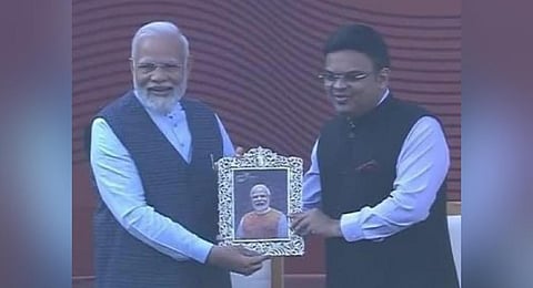 PM Modi being given a framed portrait of himself by Jay Shah. (Photo | Twitter)