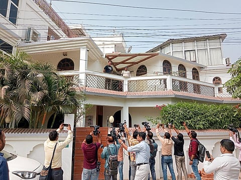 RJD leader Syed Abu Dojana (in black on balcony) at his residence during a raid by the Enforcement Directorate (ED), in Patna, on March 10, 2023. (Photo | PTI)