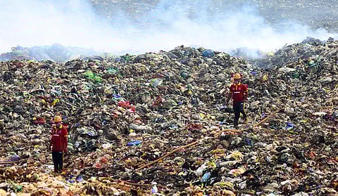 Civil Defence volunteers engaged in firefighting operations at Brahmapuram. (Photo | T P Sooraj, EPS)