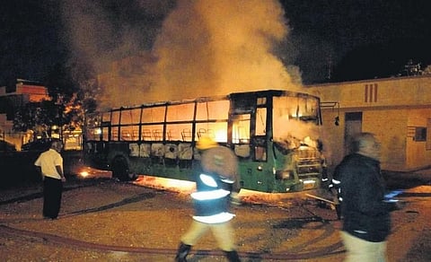 Firefighters douse the blaze that engulfed a BMTC bus, killing a conductor who was sleeping inside, in Bengaluru on Friday | Express