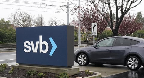 A car drives past a Silicon Valley Bank sign at the company's headquarters in Santa Clara.(Photo | AP)