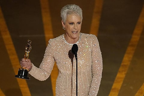 Jamie Lee Curtis accepts the award for best performance by an actress in a supporting role for 'Everything Everywhere All at Once' at the Oscars on Sunday. (Photo | AP)
