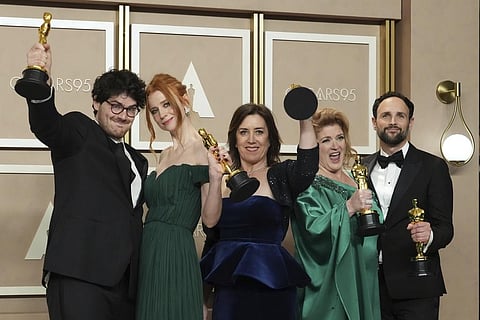 Daniel Roher, from left, Odessa Rae, Diane Becker, Melanie Miller and Shane Boris, winners of the award for best documentary feature film for 'Navalny', pose in the press room at the Oscars. (Photo |