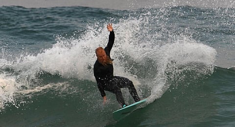 Blake Johnston surfs as he is setting out to break the world record for the longest surfing session on Cronulla Beach in Sydney on March 16, 2023. (Photo | AFP)