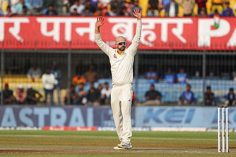 Australia's Nathan Lyon acknowledges the crowed after taking eight wickets during the second day of third cricket test match between India and Australia in Indore. (Photo | AP)