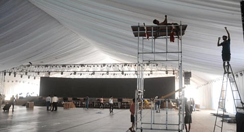 The stage is being set up at Andhra University Engineering Grounds for the Global Investors Summit in Visakhapatnam. (Express Photo | G Satyanarayana)