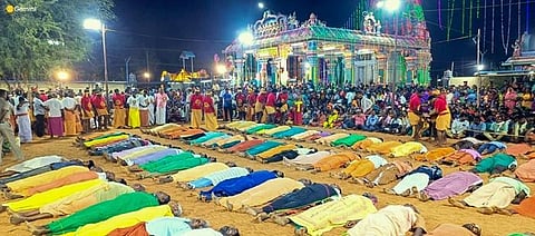 Devotees lay ‘unconscious’ at what is believed to be the place of death of one of the kings as part of Masiperunthiruvizha. Express