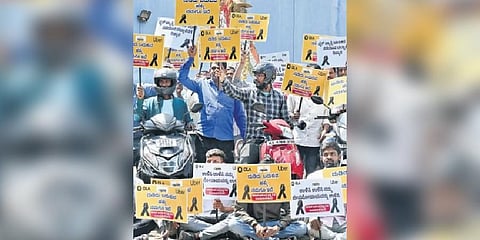Members of the Bike Taxi Association stage a protest alleging harassment by autorickshaw and cab drivers, at Freedom Park on Sunday | Shashidhar Byrappa