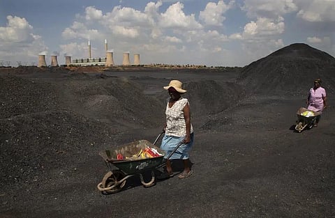 FILE - Women push wheelbarrows atop a coal mine dump at the coal-powered Duvha power station, near Emalahleni east of Johannesburg, Nov. 17, 2022. (Photo | AP)