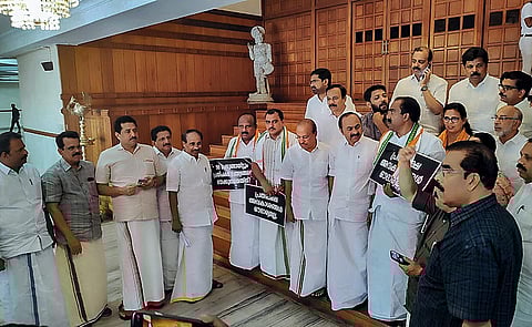 Opposition MLAs led by Leader of the Opposition in Kerala Assembly V.D. Satheesan stage a walkout from the Assembly during the Assembly Session, on March 21, 2023. (Photo | PTI)