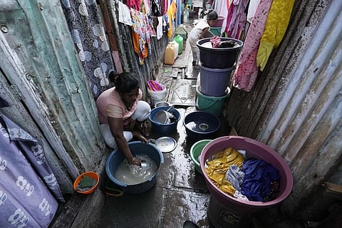 A woman washes utensils outside her house in a slum area on the eve of World Water Day in Mumbai, India, Tuesday, March 21, 2023. (Photo | AP)