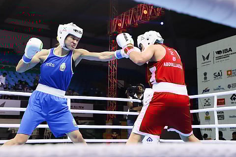 Jelena Janicijevic of Serbia (in blue) throws a jab during her bout in IBA World Championships.